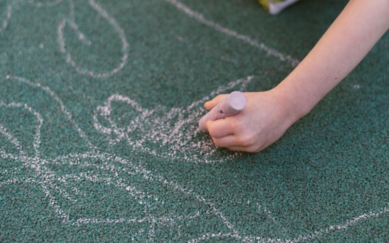 child-draws-with-chalk-street-special-coating-drawing-playground.jpg